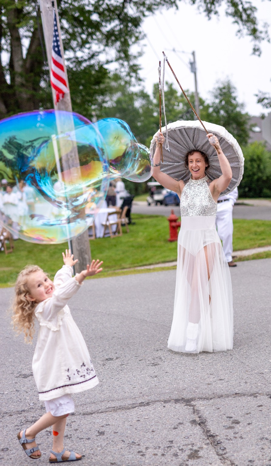Amelia performing on stilts with giant bubbles