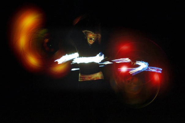 Amelia performing with a fire hoop during her early hoop training