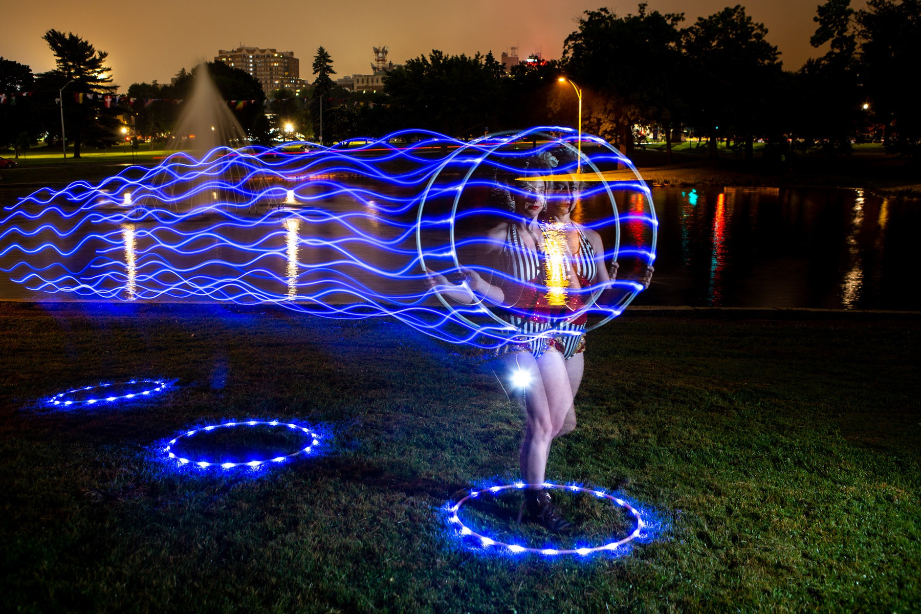 Amelia hooping at dusk, leaving flowing trails of blue light