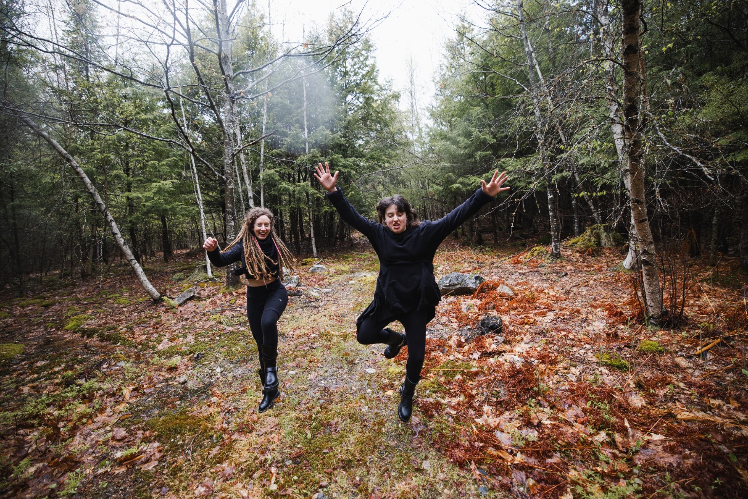 Amelia and her daughter Ember jumping in the woods
